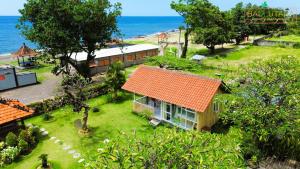 an aerial view of a house with an orange roof at Rumah Putih Beachfront Bungalow in Tegallengah