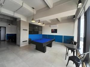 a ping pong table in a large room with blue walls at Modern loft with panoramic views in Monterrey