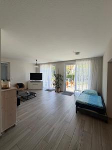 a large living room with a bed and a television at Ferienhaus Tafolli in Linsengericht
