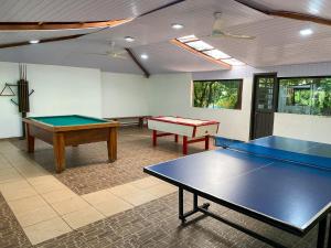 a room with two ping pong tables in it at Los Lagos Resort Hotel in Capiatá