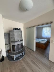 a bedroom with a bed and a wooden floor at Ferienhaus Tafolli in Linsengericht