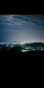 a view of a city at night with lights at Mussoorie Lodge in Mussoorie