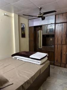 a bedroom with a bed and a ceiling fan at Mussoorie Lodge in Mussoorie