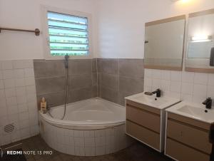 a bathroom with a tub and a sink at NM-Housing in Saint-Denis