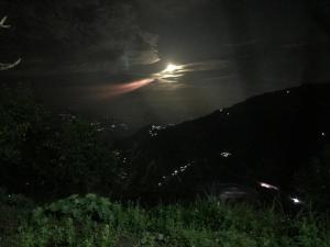 a night time view of a mountain with the moon at Mussoorie Lodge in Mussoorie