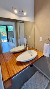 a bathroom with two surfboards on a wooden counter at Cabañas Indómita in El Bolsón +28 photos