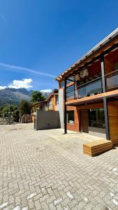 a large building with a stone driveway in front of it at Cabañas Indómita in El Bolsón