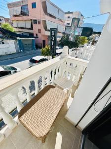 a bench sitting on the balcony of a building at Kristian apartments in Berat