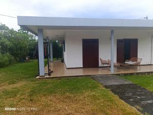 a house with a covered porch with a table and chairs at NM-Housing in Saint-Denis