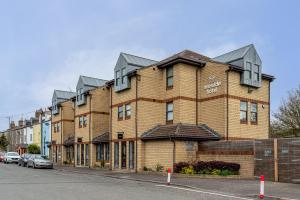 a large brick building on the side of a street at Riverside Hotel in Cirencester