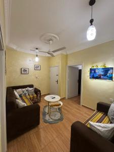 a living room with a couch and a table at CozyQ Apt in Aqaba