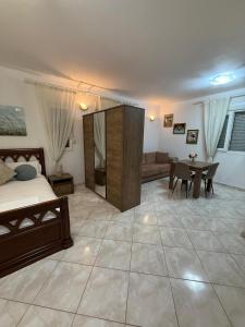 a bedroom with a bed and a couch and a table at Appartament Luna in Šorići