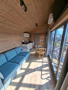a living room with a blue couch and a table at Sümeg Horizon in Sümeg