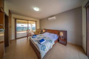 a bedroom with a bed with a view of the ocean at Infinity Blue Villa w Pool in Pomos +60 photos