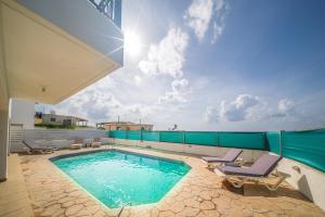 a swimming pool on the roof of a house at Infinity Blue Villa w Pool in Pomos