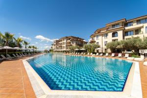 a swimming pool at a resort with buildings at Burgas Beach Resort Apartments in Burgas