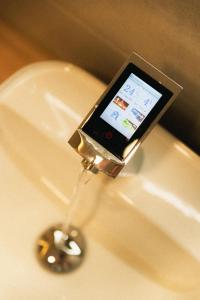 a cell phone sitting on top of a sink at Futurotel Space Spa Madrid Center in Madrid