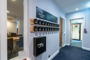 a room with a row of cell phones on a wall at Riverside Hotel in Cirencester