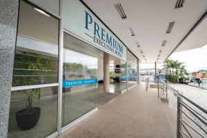 a building with a sign on the side of it at Premium Executive Hotel Itabira in Itabira