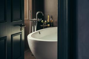 ein Badezimmer mit einer weißen Badewanne in einem Zimmer in der Unterkunft Lyla Rooms in Edinburgh