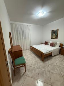 a bedroom with a bed and a chair at Appartament Tea in Šorići