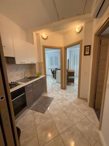 a kitchen with a sink and a stove at Appartament Tea in Šorići