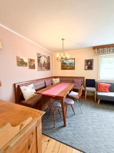 a dining room with a table and a couch at Rosis Cottage in Lienz