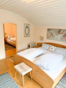 a bedroom with two beds and a mirror at Rosis Cottage in Lienz