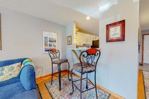 a living room with two chairs and a table at Flip Flops Inn in Duck +17 photos