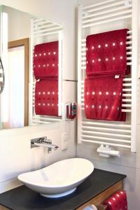 a bathroom with a white sink and red towels at Altkölnischer Hof in Bacharach +92 photos