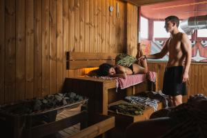 a man standing in a room with a woman in a bunk bed at The Saints Inn & Spa in Athens