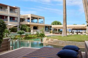 a resort with a swimming pool and a building at Atlantica Kalliston Resort - Adults Only in Stalos