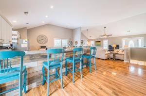 a kitchen and living room with blue bar stools at Gone With The Wind - Duck, Gull's Flight, 325 Yds to Beach, Pool, Hot Tub, Pets OK, Quiet St, Flex Stays in Duck