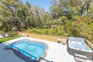 a swimming pool and a hot tub on a patio at Gone With The Wind - Duck, Gull's Flight, 325 Yds to Beach, Pool, Hot Tub, Pets OK, Quiet St, Flex Stays in Duck