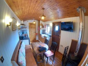 a small room with a table in a tiny house at Herston Caravan & Camping in Swanage