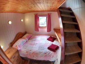 a small bedroom with a bed and a staircase at Herston Caravan & Camping in Swanage