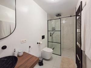 a bathroom with a toilet and a glass shower at Suite Design Balnéo - Lit King size - Garage privé in Tournai +23 photos
