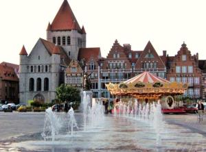 a fountain in front of a city with a building at Suite Design Balnéo - Lit King size - Garage privé in Tournai