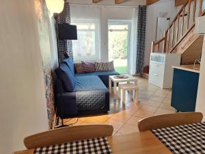 a living room with a couch and a table at Pokoje Podzamcze in Stare Drawsko