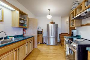 a kitchen with a stainless steel refrigerator and wooden cabinets at Wildberry Cottage in Bomoseen