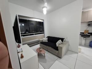 a living room with a couch and a flat screen tv at AP a 3KM das PRAIAS, com SUÍTE in São Luís