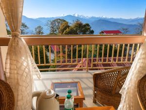 a balcony with a table and a view of mountains at Shikher Guest House in Kalimpong +24 photos