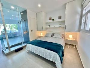 a bedroom with a large bed with two tables at Blue Oasis in Tacoronte