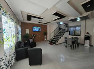 a living room with a couch and a table at Rweydz Guest Inn Dorm in Tagbilaran City