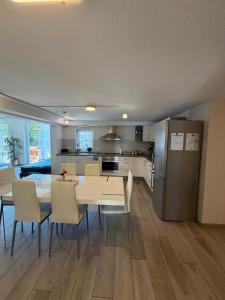 a kitchen and dining room with a table and chairs at Ferienhaus Tafolli in Linsengericht