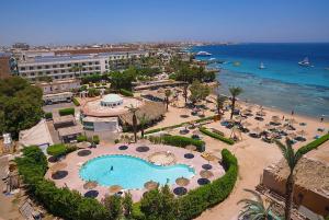 an aerial view of a resort with a swimming pool and the ocean at Dexon Roma Down Town Hotel in Hurghada