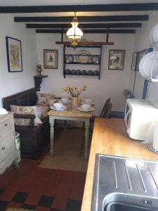 a living room with a table and a couch at 7 Front Street in Saint Johns Chapel