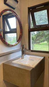 a bathroom sink with a mirror next to a window at Loto San Lorenzo Studio I balcón, vista cerros y piscina in San Lorenzo
