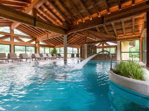 a pool with a water fountain in a house at Hotel Elisabeth, 4 Sterne Superior in Kirchberg in Tirol