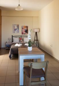 a living room with a table and a bed at Kanali seaside apartment Poros 2 in Poros +3 photos